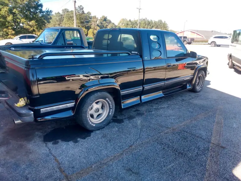 A pickup finished in gloss black, back outside after paint